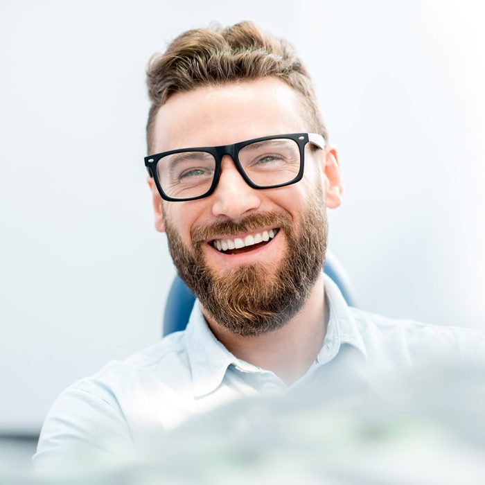 Handsome businessman with great smile sitting on the dental chair