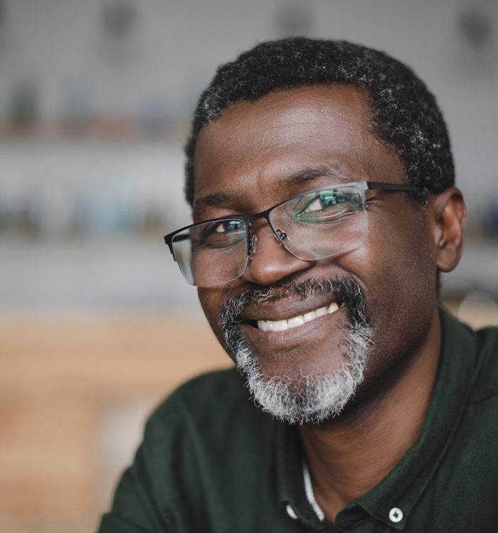 close-up portrait of smiling mature african american man in bar