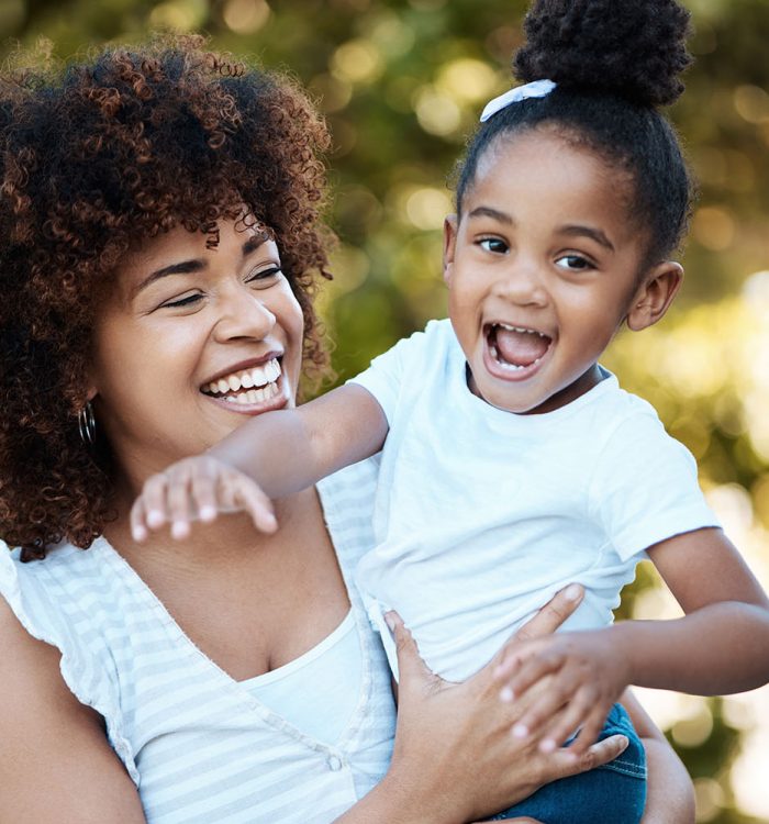 Happy, love and mother with child in nature at an outdoor park playing, bonding and having fun. Smile, excited and young mom carrying her girl kid or toddler walking in a green garden in Mexico